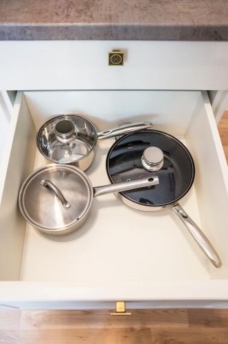 a drawer with three pots and pans on top of it at Design Apartment Havelska in Prague