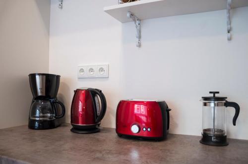 three appliances sitting on a counter in a kitchen at Design Apartment Havelska in Prague