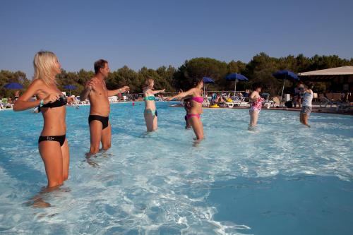 a group of people in the water at a swimming pool at Club Esse Gallura in Aglientu
