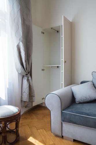 a living room with a couch and a table at Design Apartment Havelska in Prague