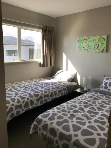 a bedroom with two beds and a window at Cromwell Safari Bach in Cromwell