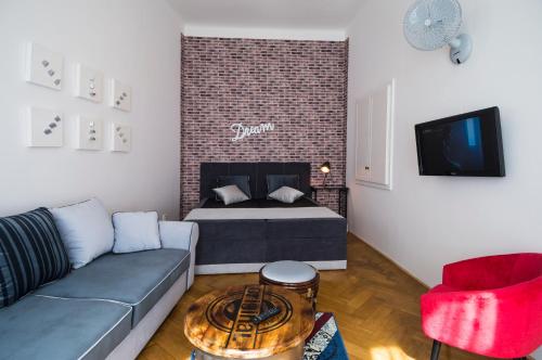 a living room with a couch and a bed at Design Apartment Havelska in Prague