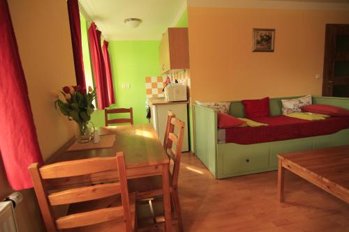 a kitchen and dining room with a table and a small room at Stara Mlekarna in Kytlice