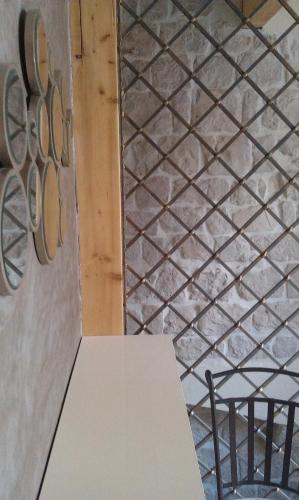 a white table in a room with a stone wall at Villa Kudelik - Stone Story in Trogir