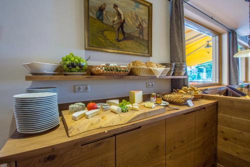 a kitchen with a table with food on it at Hotel Babymio in Kirchdorf in Tirol