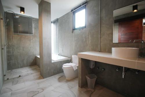 une salle de bains avec lavabo et toilettes dans l'établissement Unique Loft Apartment, à Kamala Beach