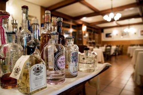 a group of bottles of alcohol sitting on a table at Lokanda Devetak in Savogna dʼIsonzo