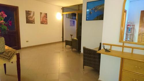 a room with a hallway with tables and chairs at Il Complesso Saraceno in Torre delle Stelle