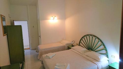 a hotel room with two beds and a mirror at Il Complesso Saraceno in Torre delle Stelle
