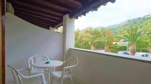 a small table and chairs on a balcony with a view at Il Complesso Saraceno in Torre delle Stelle