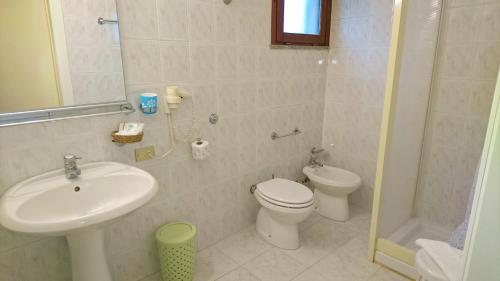 a bathroom with a sink and a toilet and a shower at Il Complesso Saraceno in Torre delle Stelle