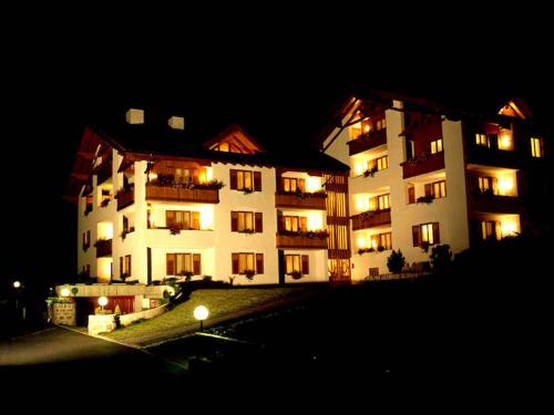 a large building at night with its lights on at Residence Stefenine in Molveno