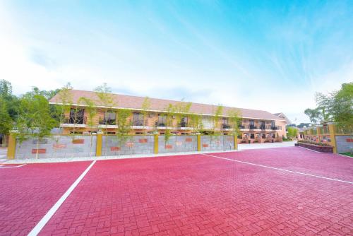a tennis court in front of a building at Kabaleyan Cove Resort powered by Cocotel in San Carlos