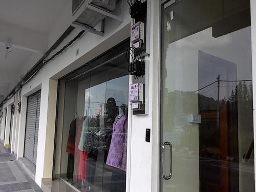 a store window with a bunch of clothes in it at Pusat Penginapan The CityScape - Cukup Rehat & Lena Hingga Pagi in Lumut