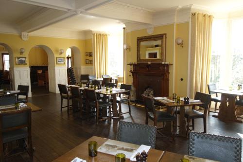 a restaurant with tables and chairs in a room at Kilmarnock Arms Hotel in Cruden Bay