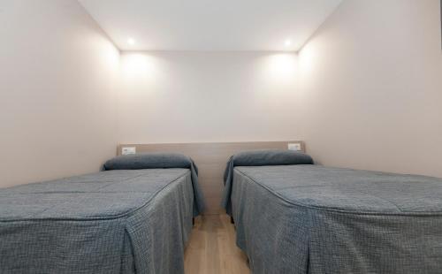 Katil atau katil-katil dalam bilik di Apartamentos Apolo Somo