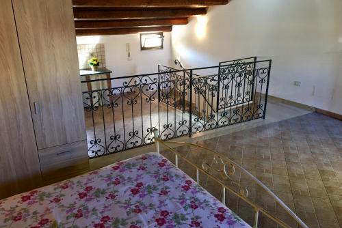 a room with a staircase with a wrought iron railing at Al Duomo in Partinico