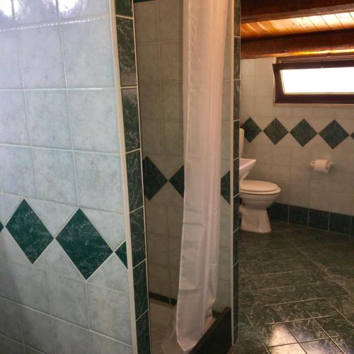 a bathroom with a toilet and a glass shower at Al Duomo in Partinico