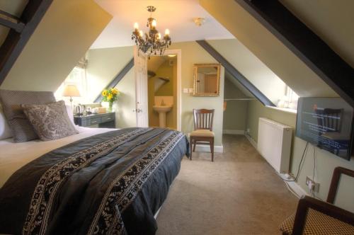 a bedroom with a large bed and a bathroom at Dunster Castle Hotel in Dunster