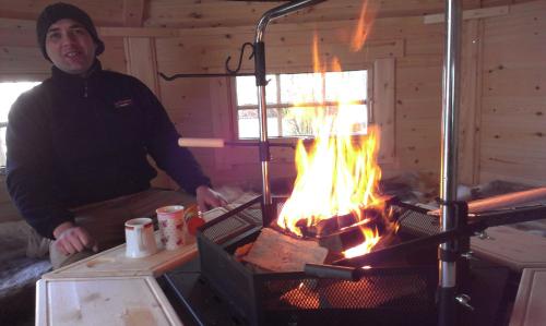 a man is standing in front of a fire at Ortmanns Eulennest in Finnentrop