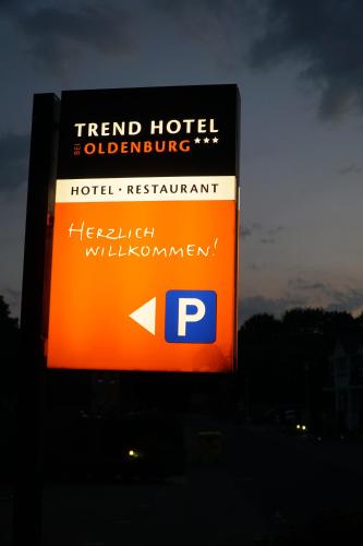 a sign for a hotel restaurant with an arrow on it at Trend Hotel in Oldenburg
