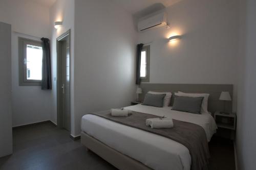 a bedroom with a large bed with two pillows on it at Angelique Apartment in Antiparos