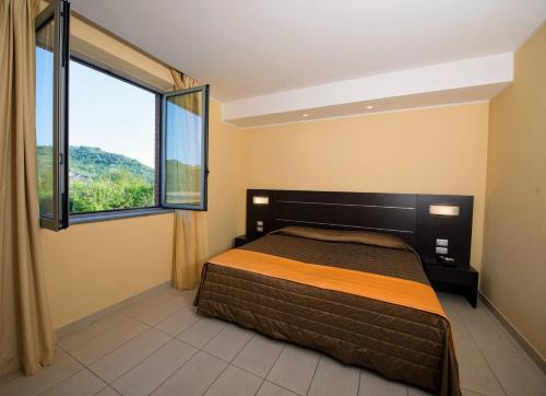 Postel nebo postele na pokoji v ubytování Hotel Letizià