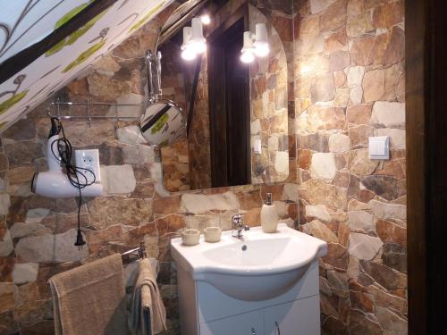 a bathroom with a sink and a stone wall at Mlýn Isabellental - Isabellino údolí in Stříbro