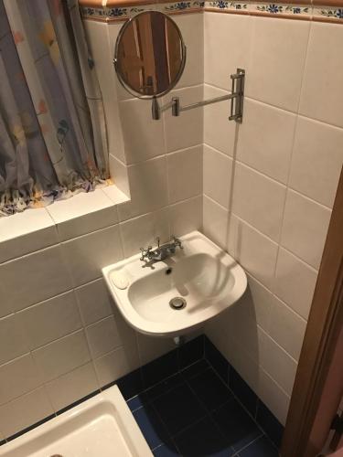 a bathroom with a sink and a mirror at Swieqi Semi Detached Maisonette in St Julian's