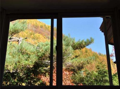a window with a view of a mountain at Poetical in Matsumoto