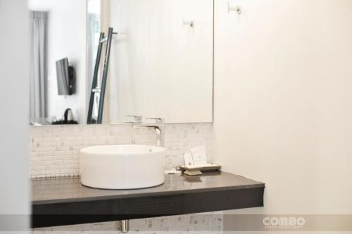 a bathroom with a white sink and a mirror at Combo Beach Hotel Samui in Chaweng