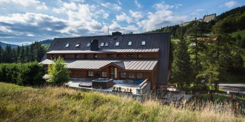 an overhead view of a large house with a roof at Hotel Stoh in Špindlerův Mlýn