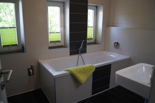 a bathroom with a large tub and a sink at Ferienwohnung Markkleeberg Ost-See in Markkleeberg