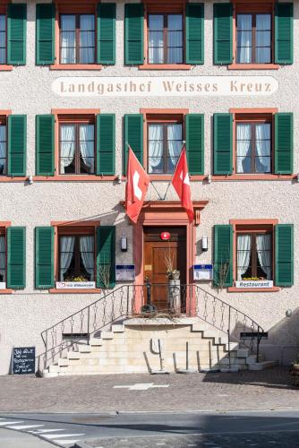 a building with the front entrance to the lancasterwest wishes hotel at Hotel-Restaurant Weisses Kreuz in Breitenbach