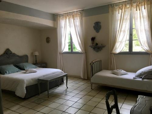 アヴィニョンにあるLa Bastide des Angesのベッドルーム1室(ベッド2台、窓2つ付)