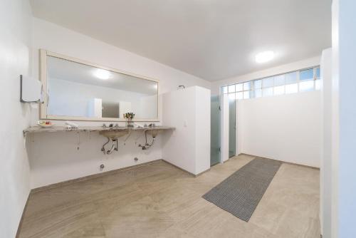 a bathroom with a sink and a mirror at Vila Suzana Parque Hotel in Canela