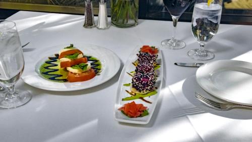 a white table with two plates of food on it at Ethan Allen Hotel in Danbury