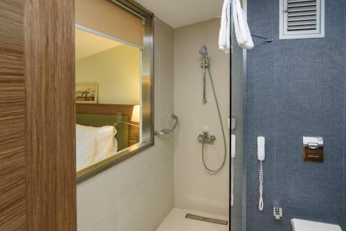 a bathroom with a shower with a mirror at Numi Hotel in Istanbul