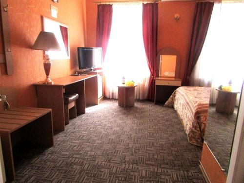 a hotel room with a bed and a desk at Old Town in Izmail