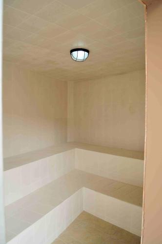 a room with shelves and a light on the ceiling at El Balcon de los Reyes in Ibarra