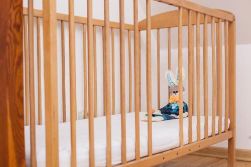 a wooden crib with a stuffed animal sitting in it at Podlesice 38 in Kroczyce