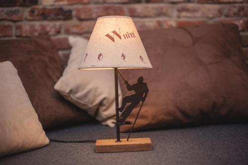a figurine of a man on a lamp on a table at Podlesice 38 in Kroczyce