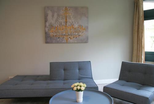 a living room with a couch and a table at Hotel Verdi in Rostock