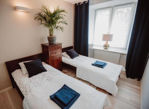 Posteľ alebo postele v izbe v ubytovaní Apartament Wisniowa