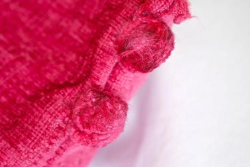a close up of a pink knitted scarf at Canaston Oaks in Narberth