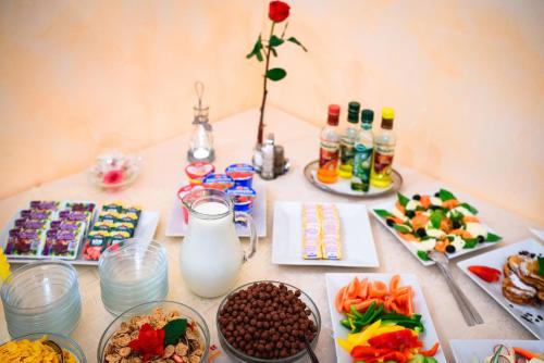 a table topped with plates of food and snacks at Hotel Kaskada in Poprad