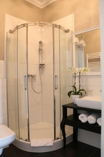 a bathroom with a shower and a toilet and a sink at Hotel Villa Casino in Słubice