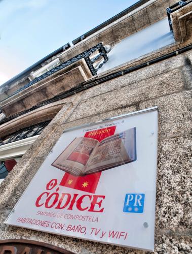 a sign on the side of a building at Pensión O Códice by Moradas Nieto in Santiago de Compostela