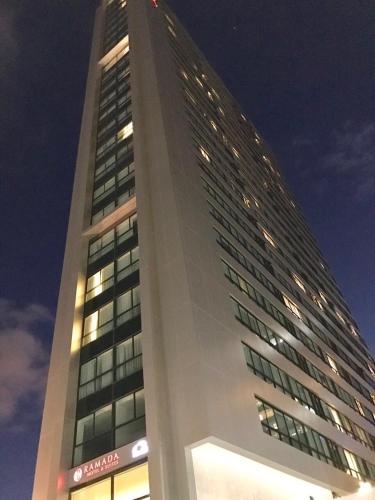 a tall building with lights on in front of it at LOFT PREMIUM Boa Viagem 20 andar in Recife