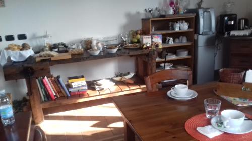 a living room with a table and a refrigerator at Agriturismo Le oche selvatiche in Lauzacco